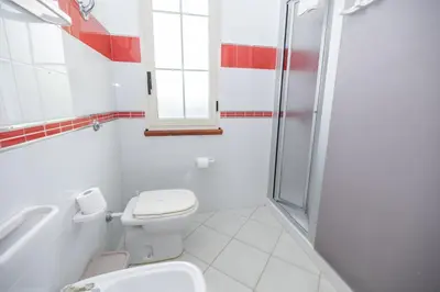 a white bathroom with a toilet and a shower at Villa Arvilla with Private POOL in Campofelice di Roccella