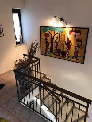 a painting on a wall with a staircase in a room at Stunning Sicilian Villa in Carini