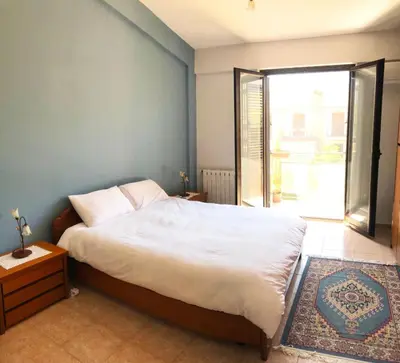 a bedroom with a large bed and a large window at Stunning Sicilian Villa in Carini