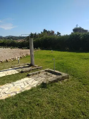 a cross on a stone path in a field at Mansarda Camelie via dei Normanni, 45 in Campofelice di Roccella