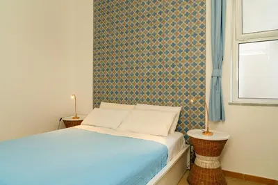 a small bedroom with a bed and a window at Casa Relax Mondello in Mondello