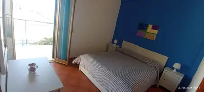a small bedroom with a bed and a table at La Casa Gialla in Trabia