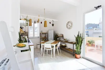 a kitchen and dining room with a table and chairs at La terrazza del Sole B&B in Palermo