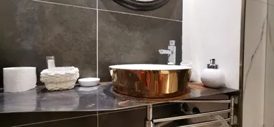 a bathroom with a large copper sink on a counter at Artisan Maison Palermo in Palermo