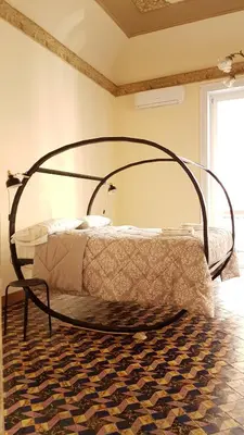 a bedroom with a bed with a metal frame at Artisan Maison Palermo in Palermo