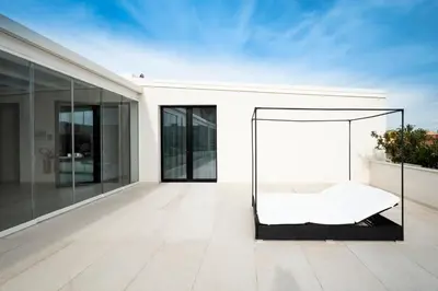 a bed on the balcony of a house at Alkamuri Posh Hotel e Spa in Alcamo