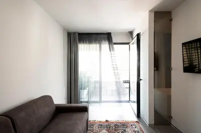 a living room with a couch and a window at Alkamuri Posh Hotel e Spa in Alcamo