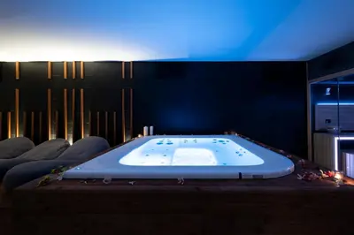 a large bath tub in a room with chairs at Alkamuri Posh Hotel e Spa in Alcamo