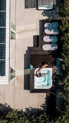 a group of swimming pools next to a building at Alkamuri Posh Hotel e Spa in Alcamo