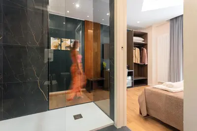 a woman in a red dress walking through a room at Quinto Stabile Rooms&Suite in Palermo