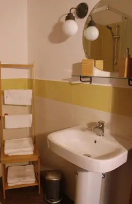 a bathroom with a sink and a mirror and towels at palermo casa vacanze in Palermo