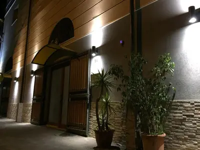 a building with two potted plants in front of it at palermo casa vacanze in Palermo
