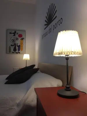 a bedroom with a bed and a table with a lamp at palermo casa vacanze in Palermo