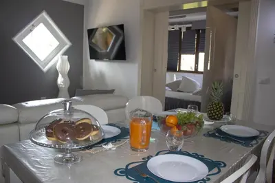 a table with a plate of food on top of it at Villa Degli Ulivi Flora in Mondello
