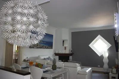 a living room with a large chandelier and a table at Villa Degli Ulivi Flora in Mondello