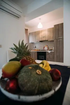 a plate of fruit on a table in a kitchen at The Lighthouse in Trappeto