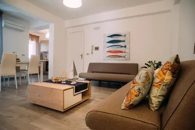 a living room with a couch and a coffee table at The Lighthouse in Trappeto