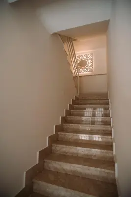 a set of stairs in a building with a chandelier at The Lighthouse in Trappeto