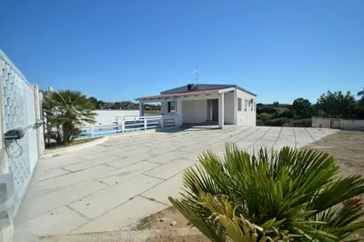 a large patio with a small white building at Villa Bianca e Villa Arancio in Alcamo