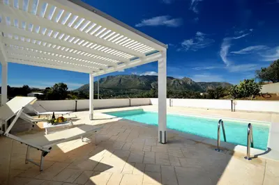 a pool with a white pergola and a swimming pool at Villa Bianca e Villa Arancio in Alcamo