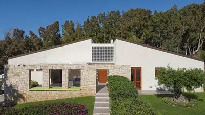a white house with trees in the background at Villa Perla del Mare in Alcamo Marina
