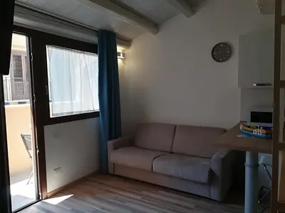 a living room with a couch and a window at Residence Mareluna in Castellammare del Golfo