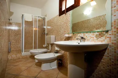a bathroom with a sink and a toilet at Residence Mareluna in Castellammare del Golfo