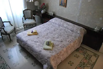 a bedroom with a bed with two shoes on it at 4You in Palermo