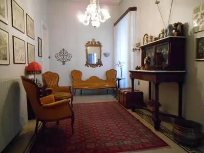 a living room with chairs and a table and a mirror at 4You in Palermo