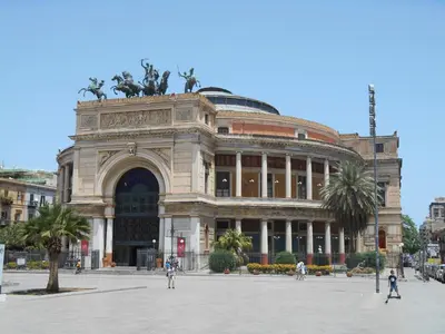 a large building with people walking in front of it at 4You in Palermo