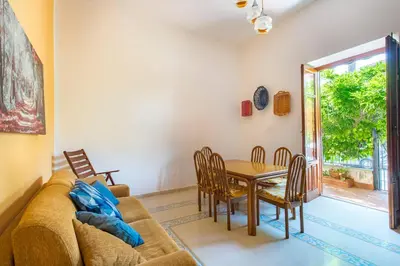 a living room with a couch and a table and chairs at La Casa di Sara a Mondello by Wonderful Italy in Mondello