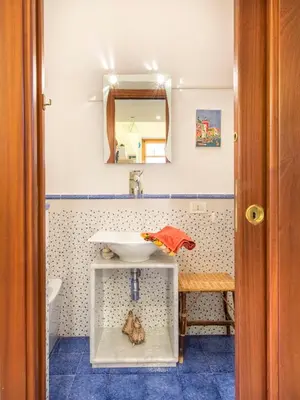 a bathroom with a sink and a mirror at La Casa di Sara a Mondello by Wonderful Italy in Mondello