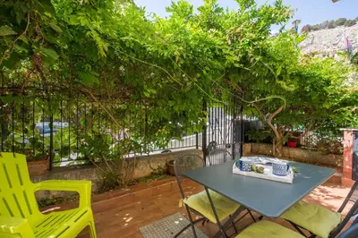 a table and chairs on a patio with trees at La Casa di Sara a Mondello by Wonderful Italy in Mondello