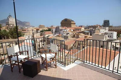 a balcony with chairs and a view of a city at Vista Capo in Palermo