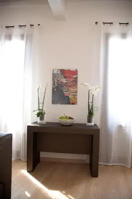 a table with vases of flowers on it in a room at Vista Capo in Palermo