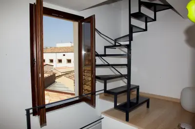 a spiral staircase in a room with a mirror at Vista Capo in Palermo