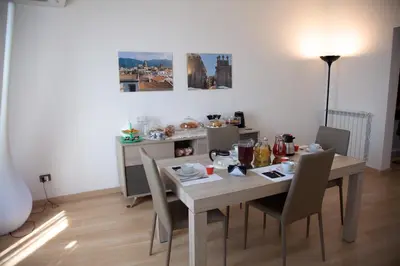 a dining room with a table and chairs at Vista Capo in Palermo