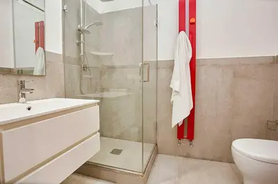 a bathroom with a shower and a sink and a toilet at KMC suites - Yellow in Palermo
