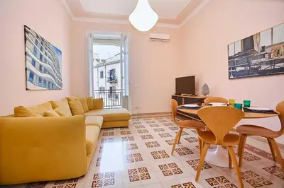 a living room with a couch and a table at KMC suites - Yellow in Palermo