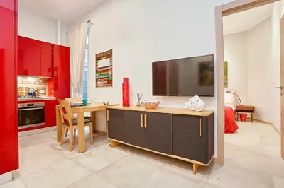 a kitchen with a desk with a tv on it at KMC suites - Red in Palermo