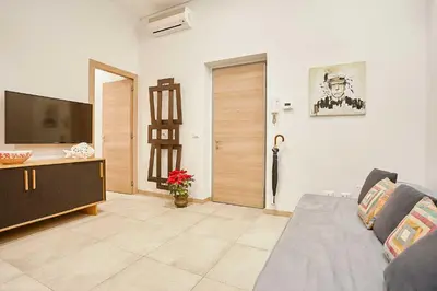 a living room with a couch and a flat screen tv at KMC suites - Red in Palermo