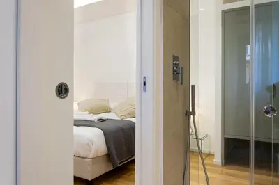 a bedroom with a bed and a glass door at Kalamonjo Suite&Rooms in Palermo
