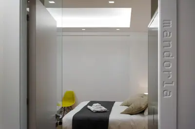 a bedroom with a bed and a mirror at Kalamonjo Suite&Rooms in Palermo