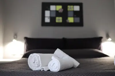 a pile of towels sitting on top of a bed at Cavour37 Rooms in Palermo