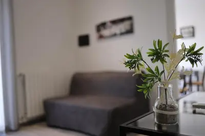 a vase with flowers on a table in a living room at Cavour37 Rooms in Palermo