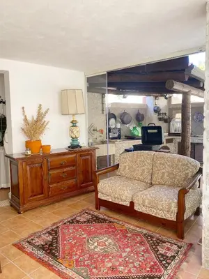 a living room with a couch and a table at La depandance di Villa Rosa locazioni brevi in Mondello