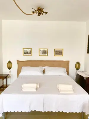 a bedroom with a bed with two towels on it at La depandance di Villa Rosa locazioni brevi in Mondello