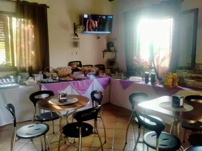 two tables and chairs in a kitchen with a counter at Hotel Grotticelli in Scopello