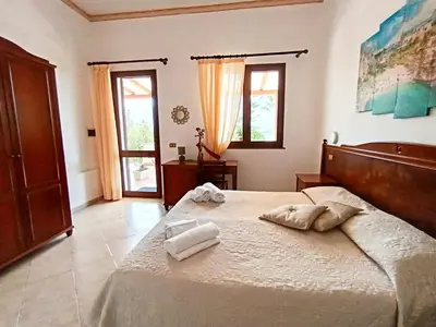 a bedroom with a bed with two towels on it at Hotel Grotticelli in Scopello