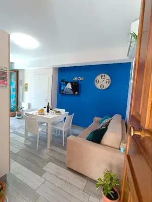 a living room with a couch and a table at Appartamento Le Ginestre in San Vito lo Capo